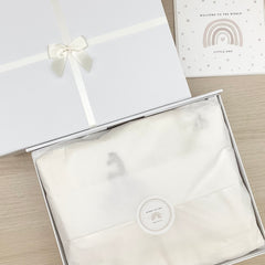 A white gift box with Ivory ribbon and a satin Ivory bow gift wrapped in luxury white tissue paper.