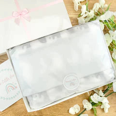 New baby gift hamper box gift wrapped in  tissue paper Box lid comes with pink ribbon and a pink satin bow